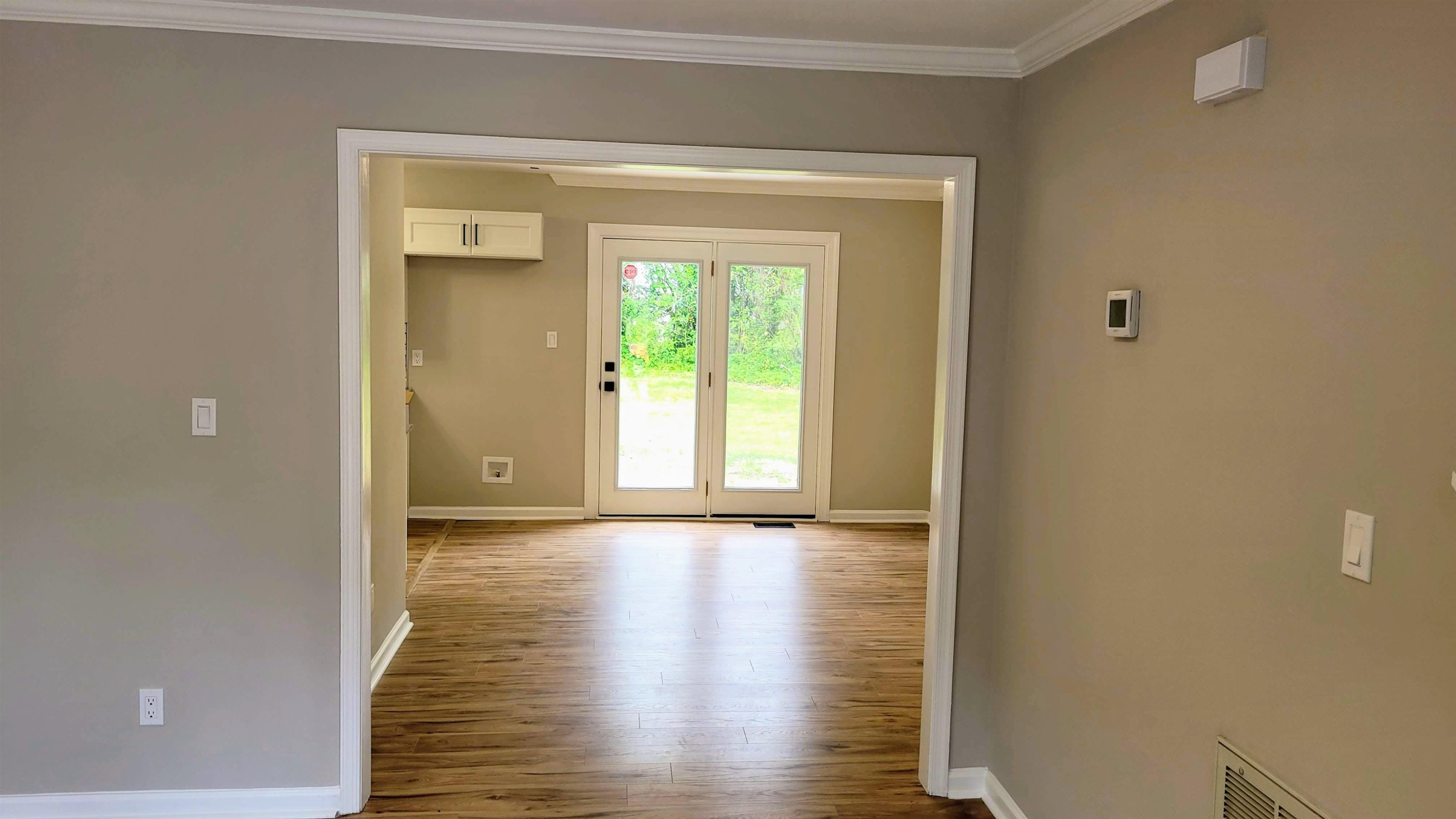 2 Austin Court Durham, NC 27707 - Photo 13 of 29 a view of an empty room with wooden floor and a window