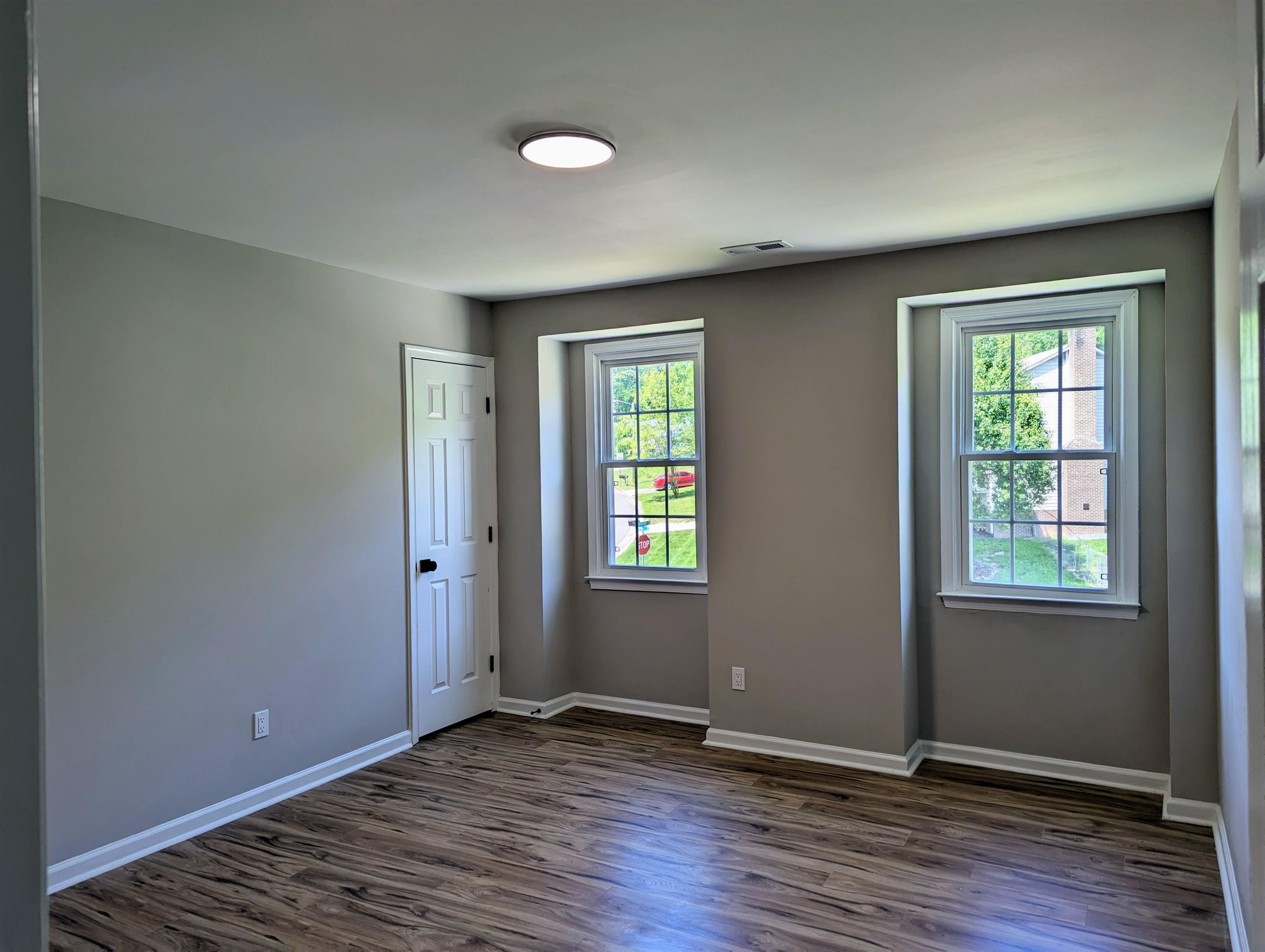2 Austin Court Durham, NC 27707 - Photo 17 of 29 an empty room with wooden floor and windows