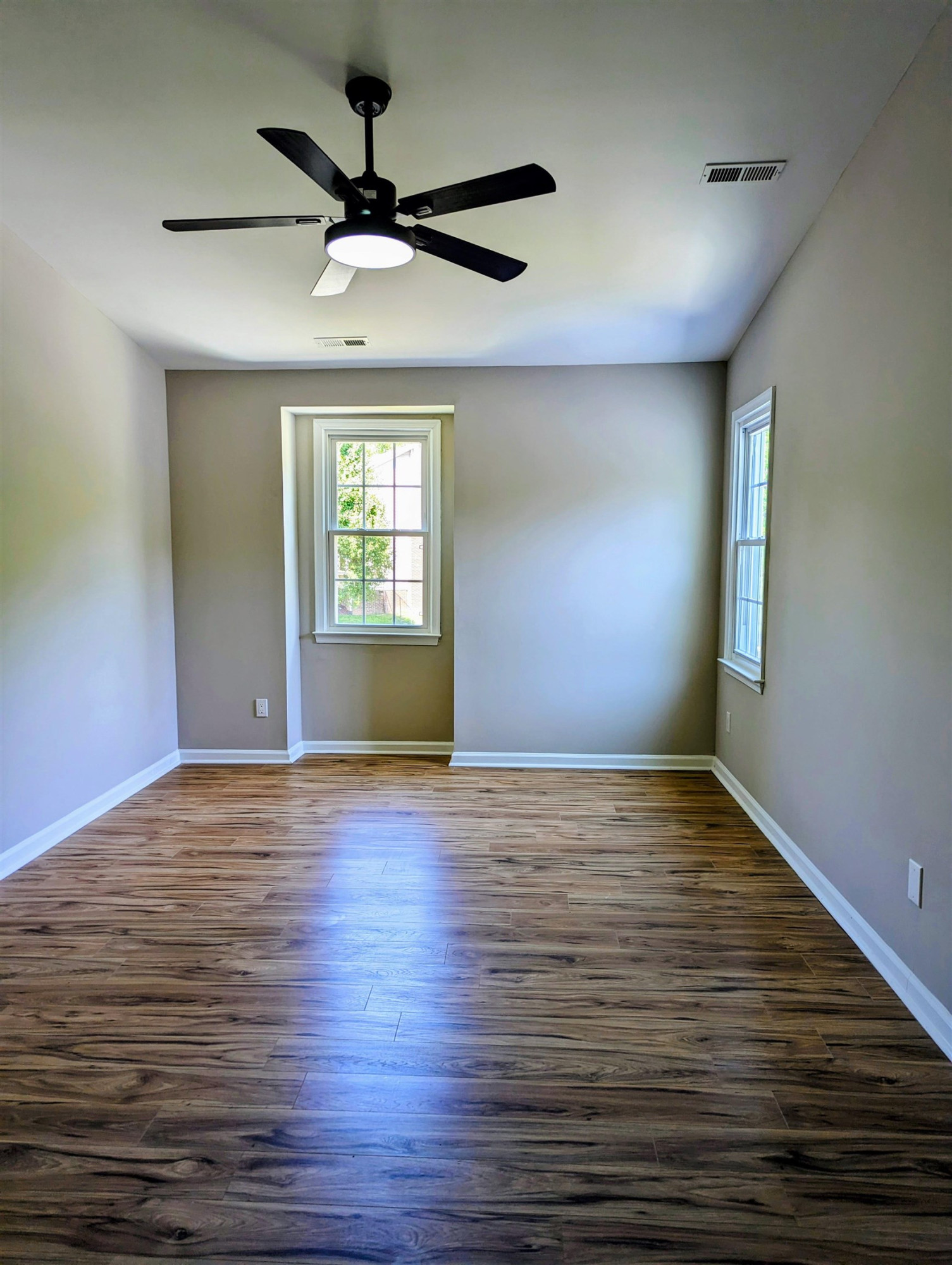 2 Austin Court Durham, NC 27707 - Photo 18 of 29 a view of an empty room with window and wooden floor