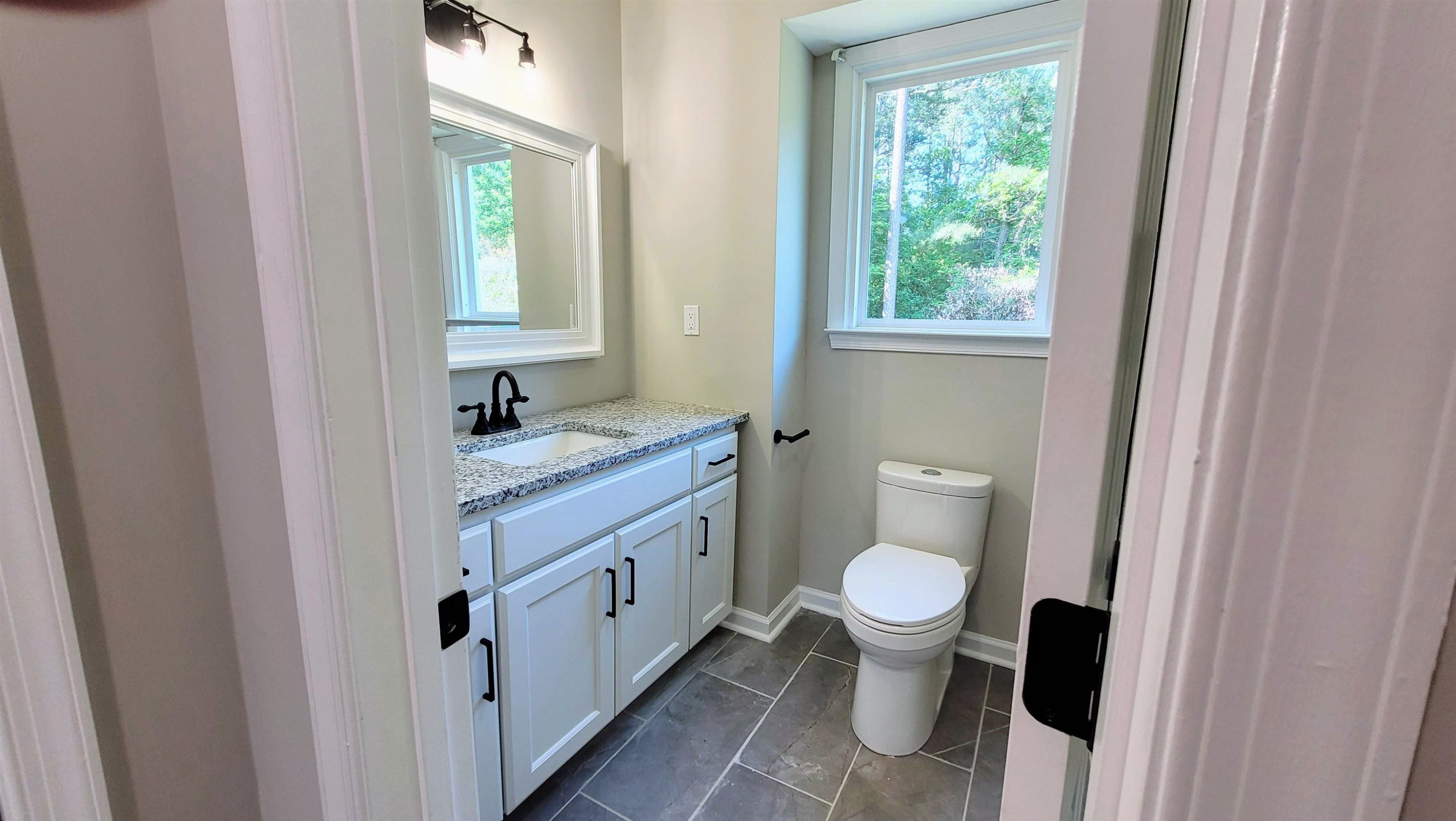 2 Austin Court Durham, NC 27707 - Photo 21 of 29 a bathroom with a granite countertop toilet and a sink