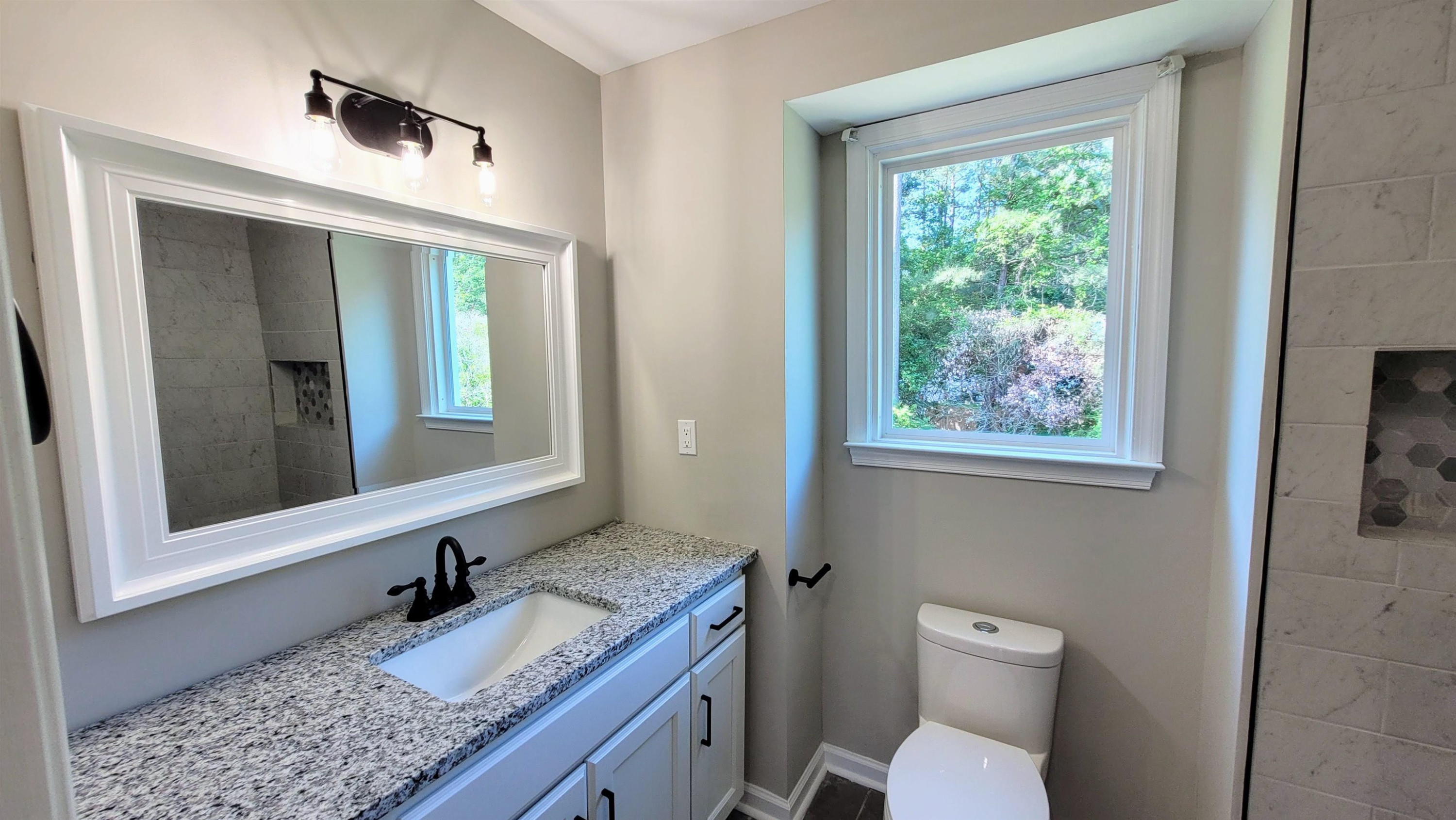 2 Austin Court Durham, NC 27707 - Photo 22 of 29 a bathroom with a granite countertop sink toilet and mirror