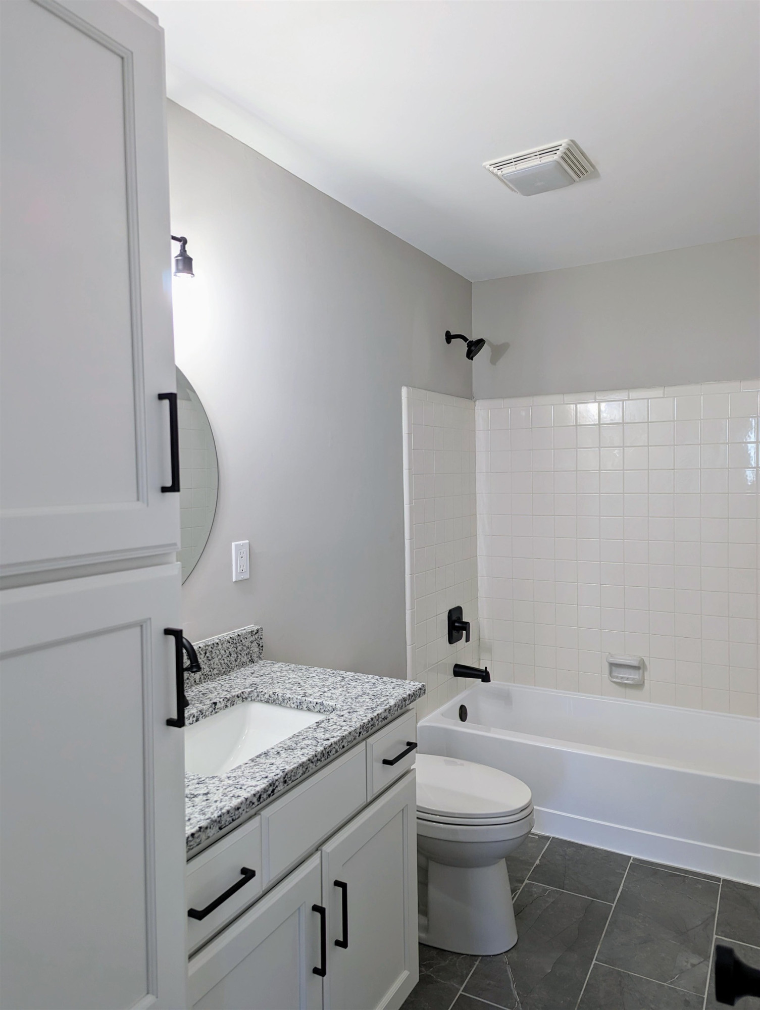2 Austin Court Durham, NC 27707 - Photo 25 of 29 a bathroom with a granite countertop sink toilet a mirror and bathtub