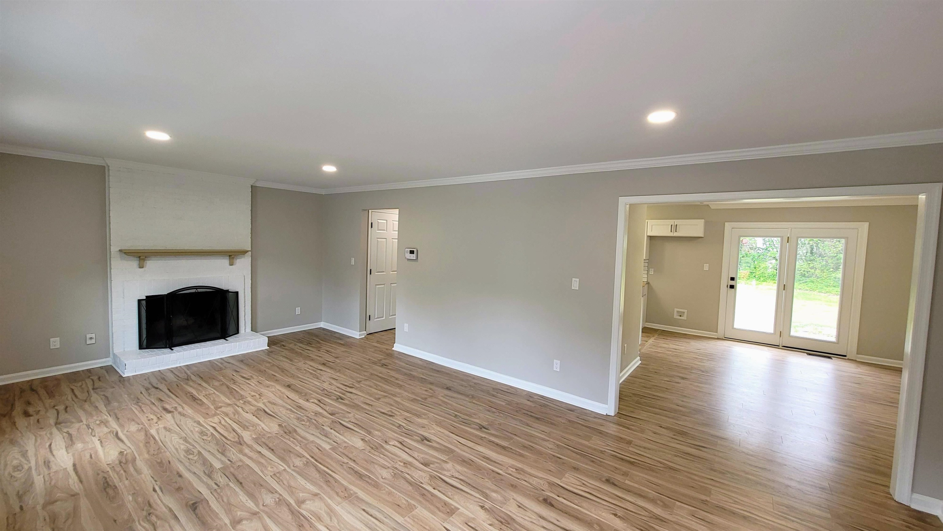 2 Austin Court Durham, NC 27707 - Photo 5 of 29 a view of an empty room with wooden floor and a window