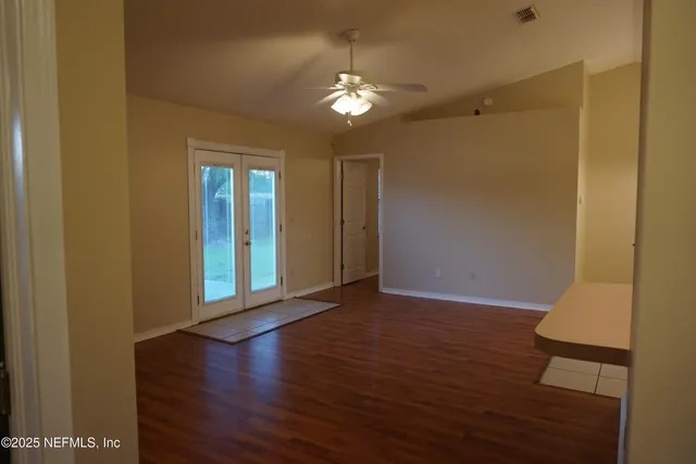 a view of a hallway with wooden floor