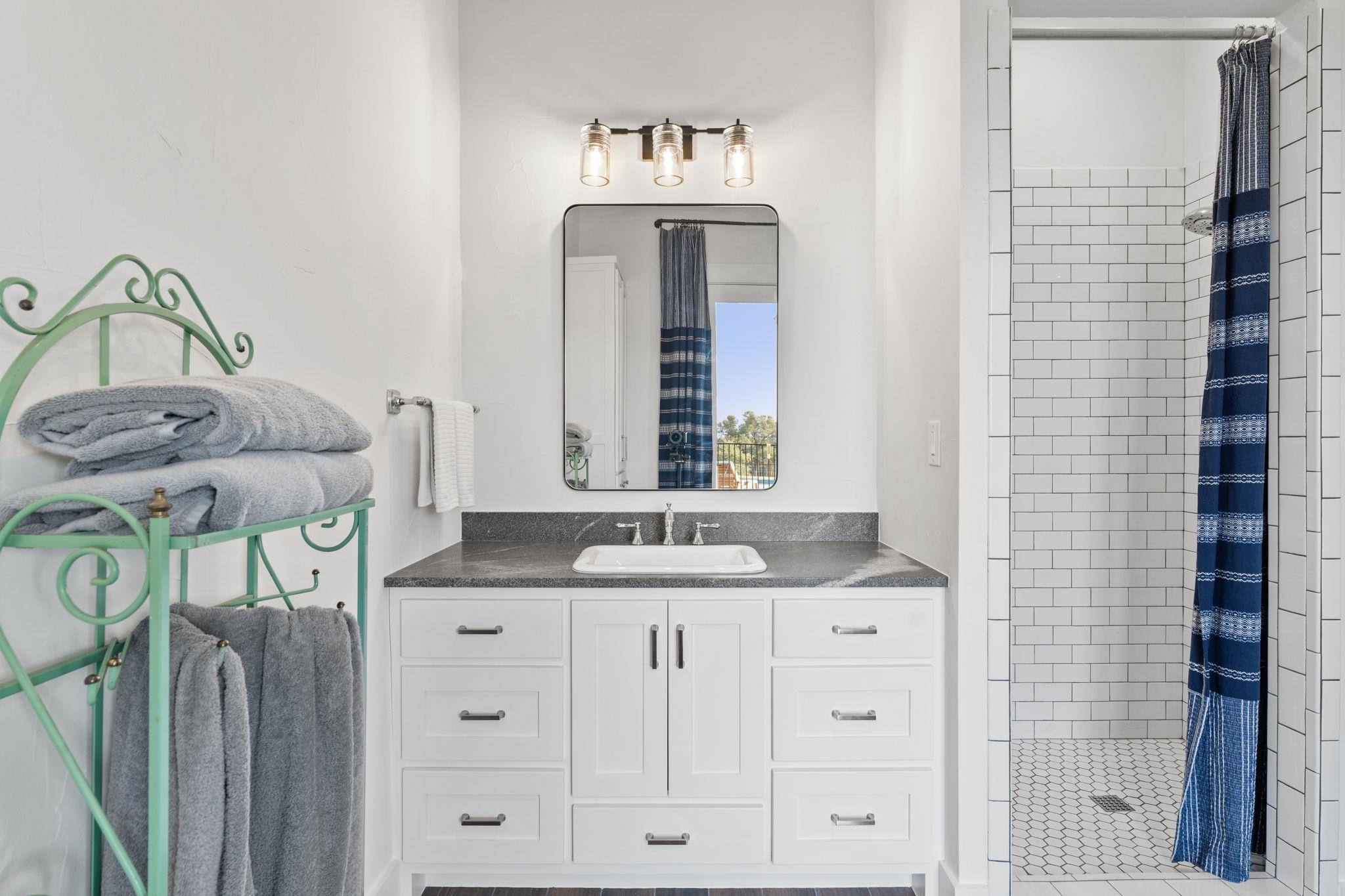 452 Southwick Ranch Road Johnson City, TX 78636 - Photo 18 of 44 a bathroom with a sink and a mirror