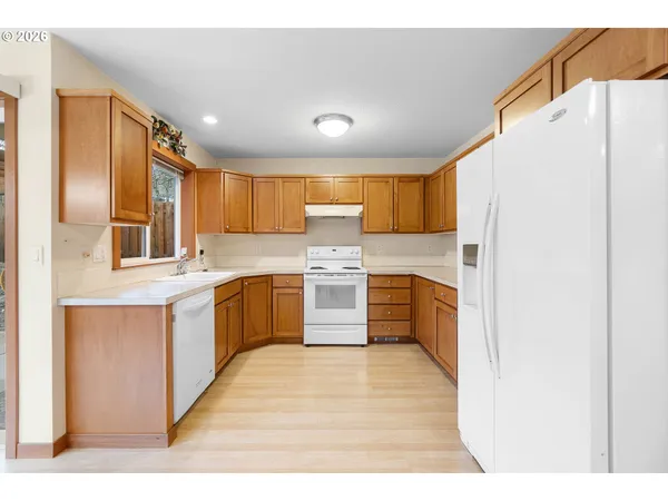 a kitchen with stainless steel appliances a refrigerator and a sink