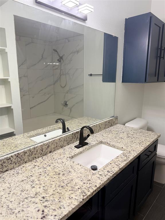 2601 Preston Road, Unit 7203 Plano, TX 75093 - Photo 15 of 27 a bathroom with a granite countertop sink and a mirror