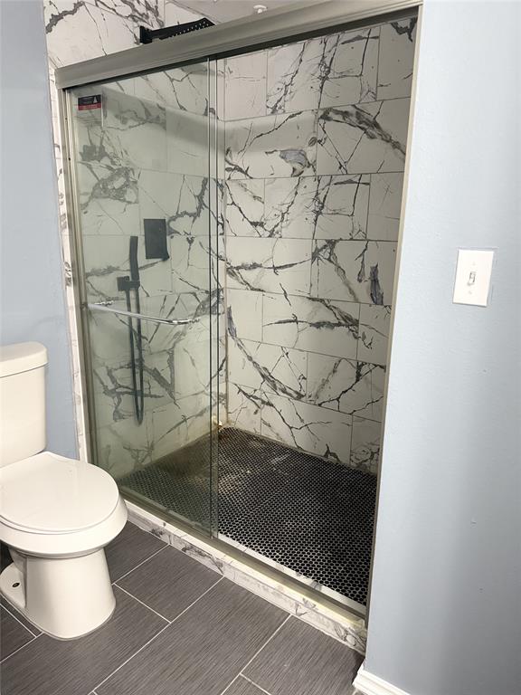 2601 Preston Road, Unit 7203 Plano, TX 75093 - Photo 18 of 27 a bathroom with a shower and a toilet