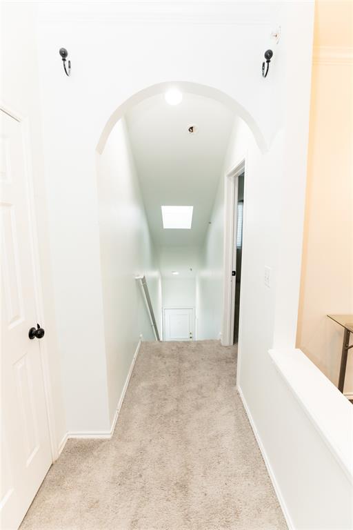 2601 Preston Road, Unit 7203 Plano, TX 75093 - Photo 21 of 27 a view of a hallway with wooden floor and a bathroom