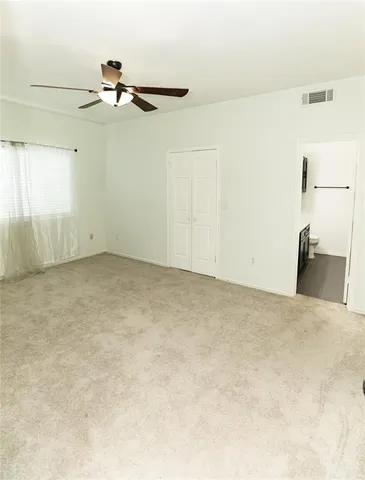 a bathroom with a granite countertop sink a toilet and mirror