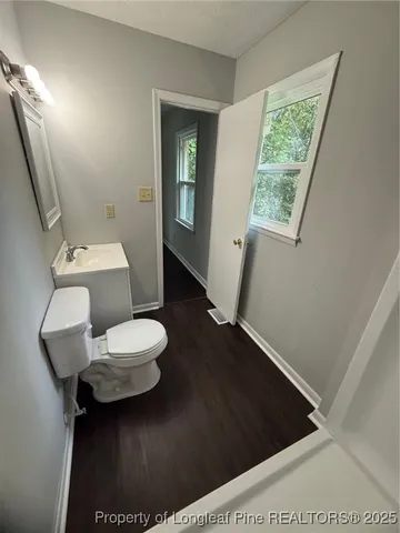 a bathroom with a toilet and a mirror