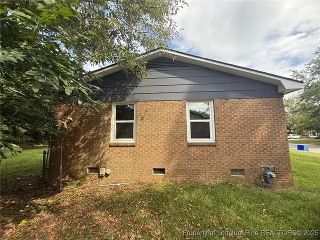 a backyard of a house with table and chairs
