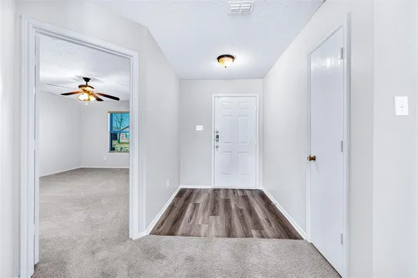 wooden floor in an empty room with a mirror
