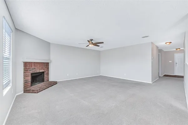 a view of an empty room with a fireplace
