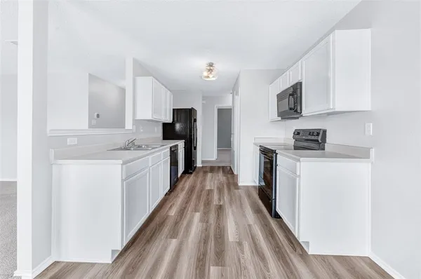 a kitchen with stove cabinets and refrigerator