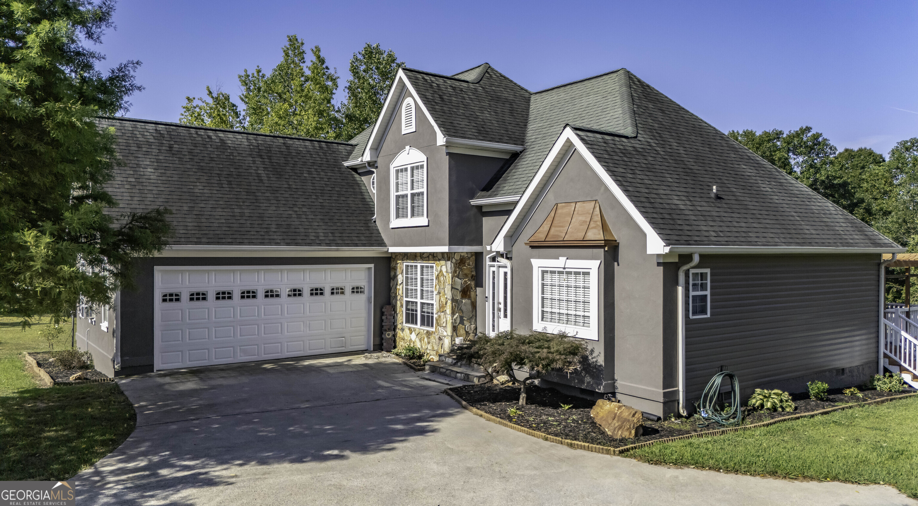 a front view of a house with a yard and garage