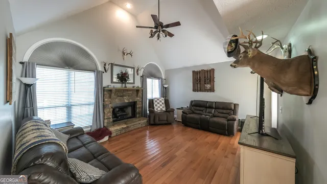 a living room with furniture fireplace and flat screen tv