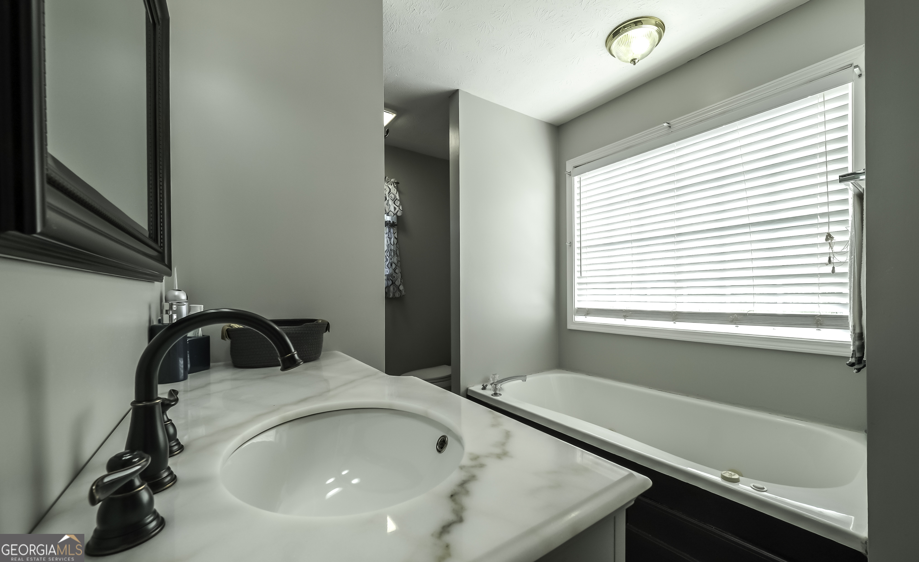 1001 Vong Street Waco, GA 30182 - Photo 16 of 45 a bathroom with a sink and a bathtub