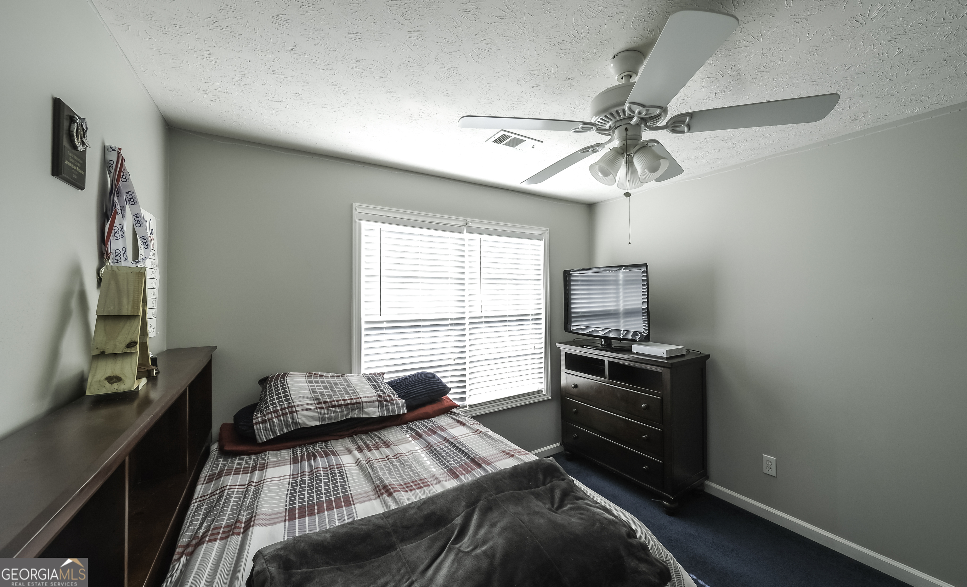 1001 Vong Street Waco, GA 30182 - Photo 28 of 45 a bedroom with a bed and a chandelier