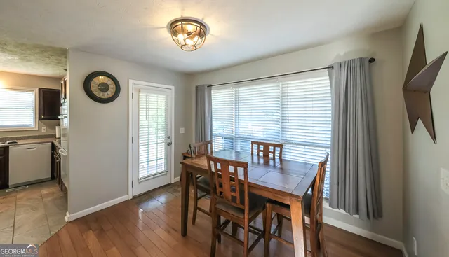 a view of a dining room with furniture window and wooden floor