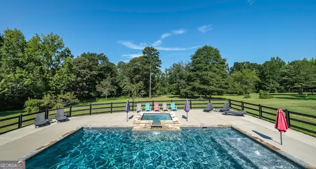a view of a park with wooden fence