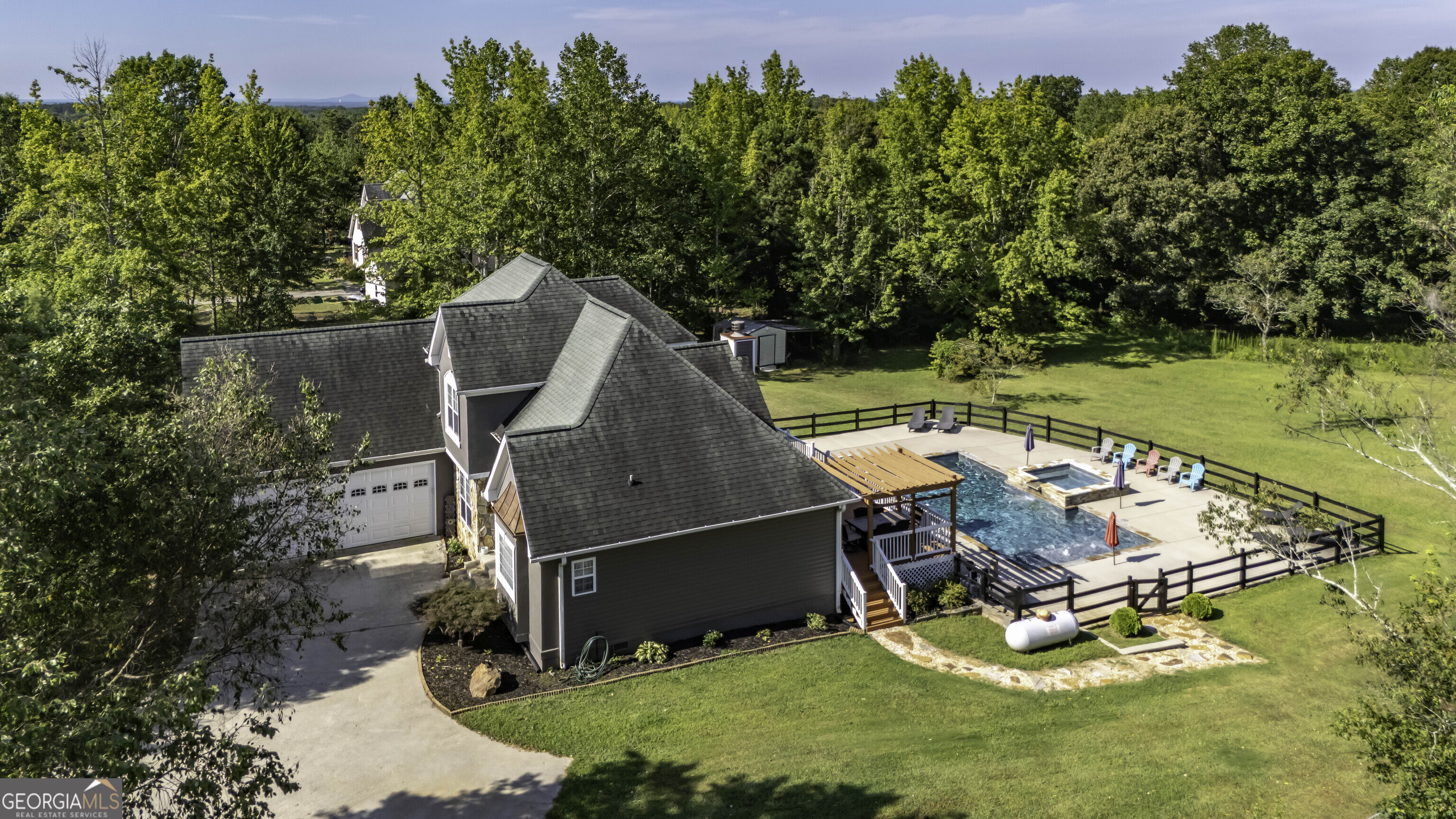 1001 Vong Street Waco, GA 30182 - Photo 41 of 45 an aerial view of a house with swimming pool and trees in the background