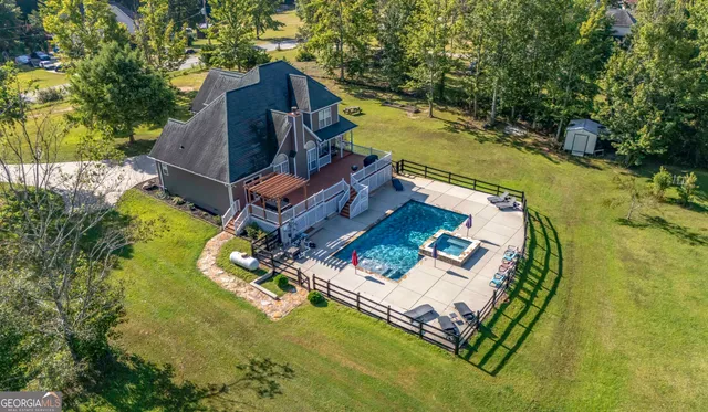 an aerial view of a house with a garden and swimming pool