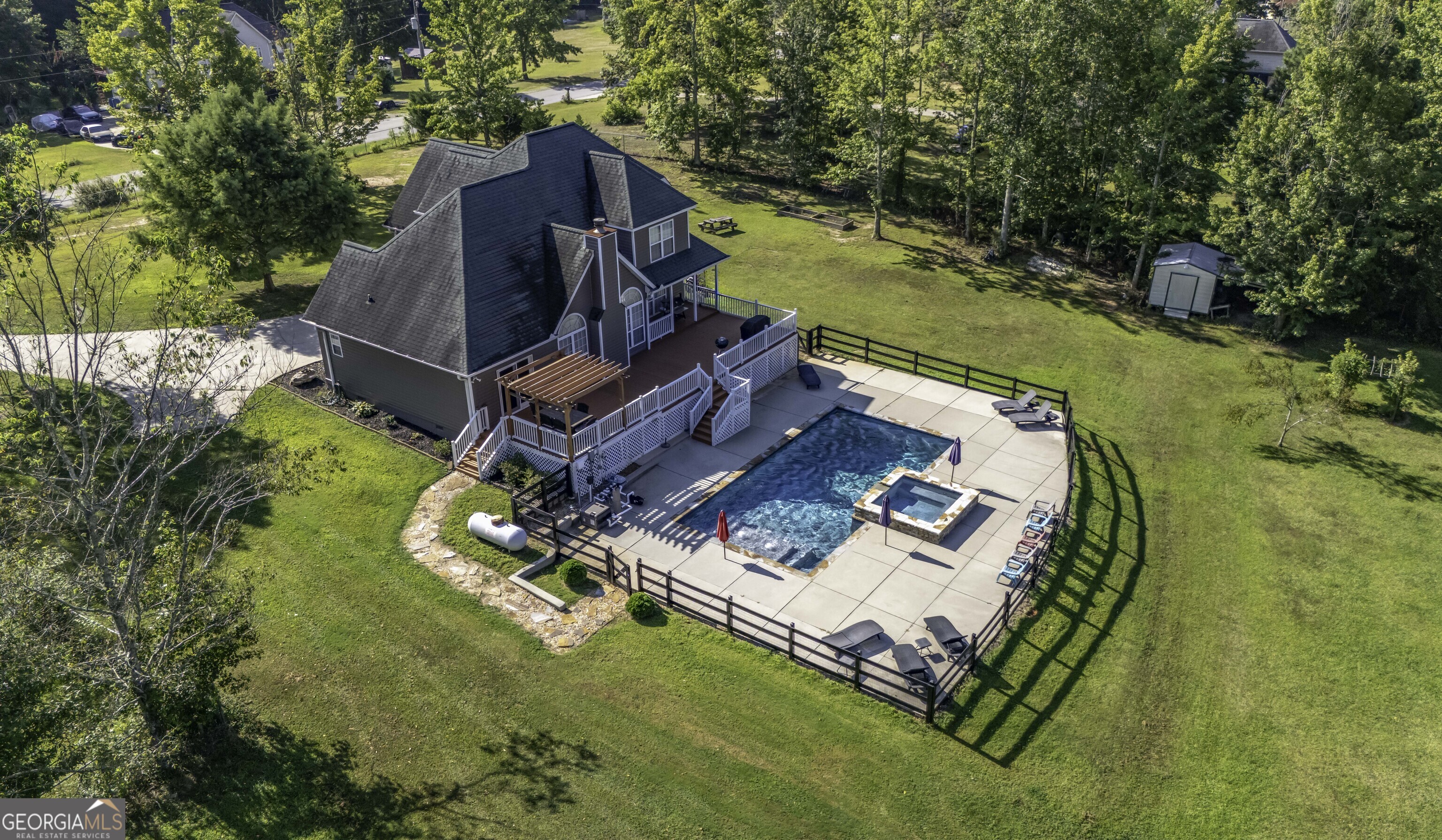 1001 Vong Street Waco, GA 30182 - Photo 42 of 45 an aerial view of a house with a garden and swimming pool