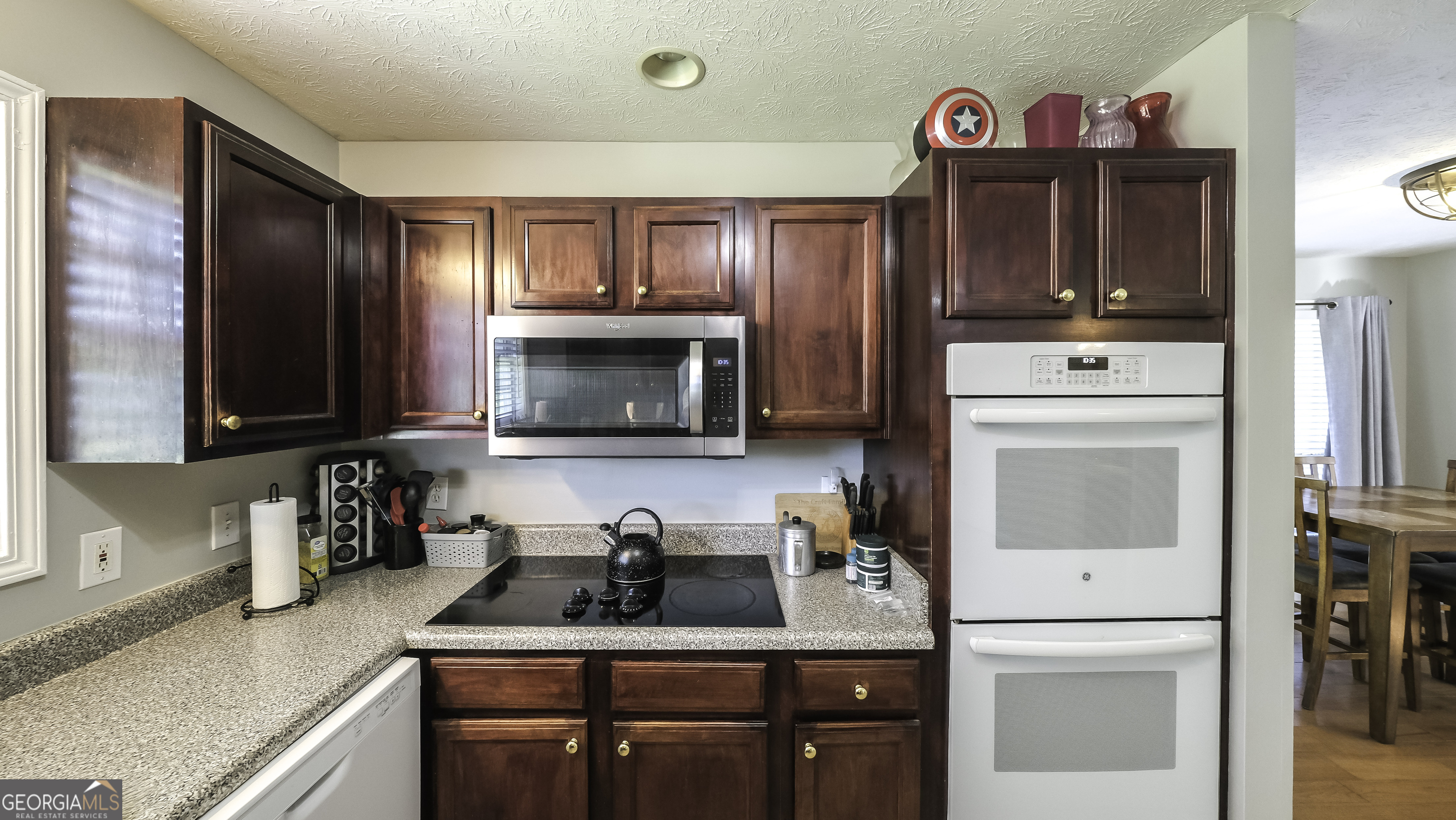 1001 Vong Street Waco, GA 30182 - Photo 7 of 45 a kitchen with granite countertop a sink and a stove top oven