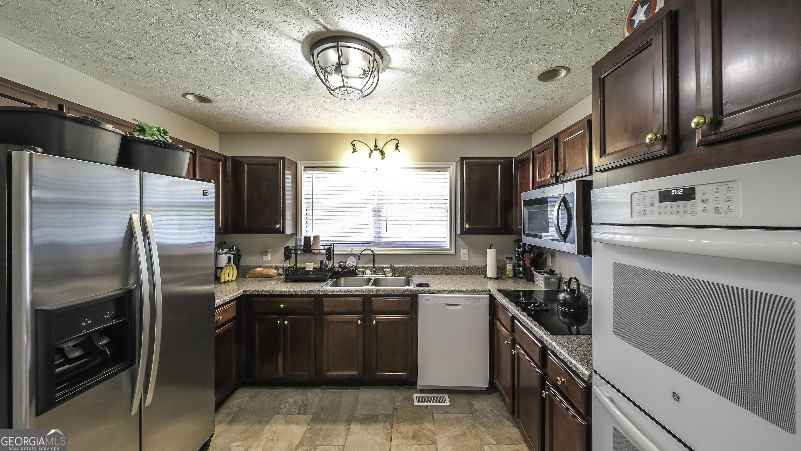 1001 Vong Street Waco, GA 30182 - Photo 8 of 45 a kitchen with a sink stainless steel appliances cabinets and a window