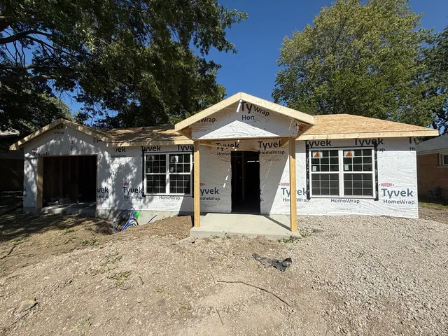 a front view of a house with garden and porch