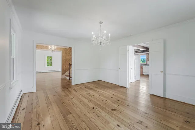 a view of a livingroom with wooden floor and a fireplace