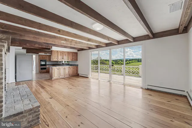 a kitchen with granite countertop a sink window and cabinets
