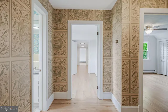 a view of an empty room with wooden floor