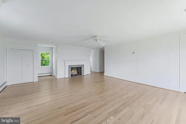 a view of an empty room and wooden floor
