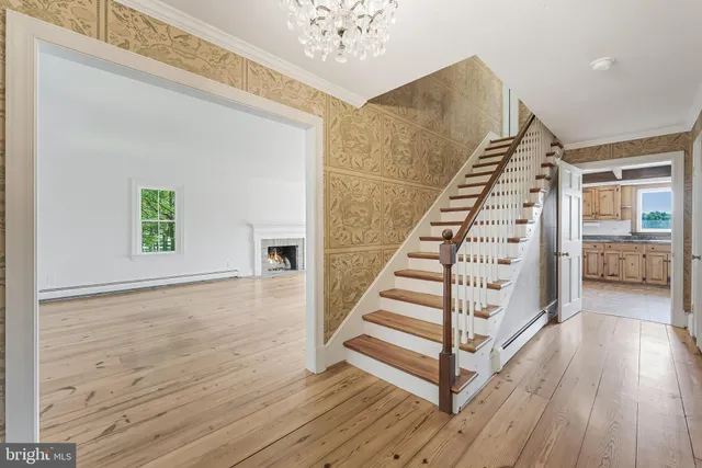 an empty room with wooden floor and fireplace