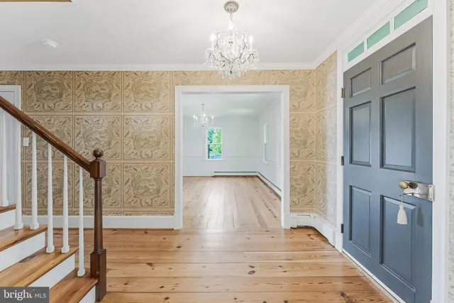 a view of empty room with wooden floor and fireplace