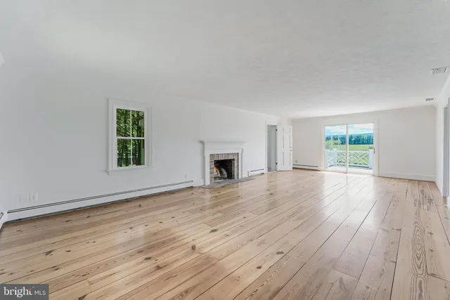 a view of kitchen with wooden floor and electronic appliances