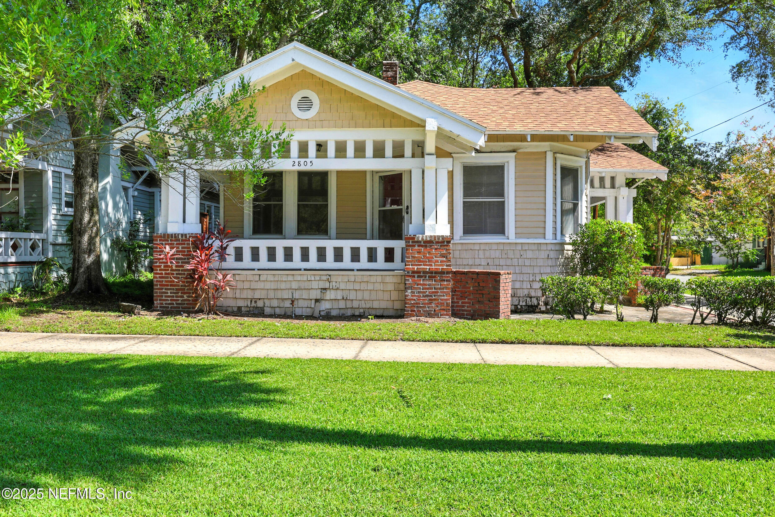 a front view of a house with a yard and porch