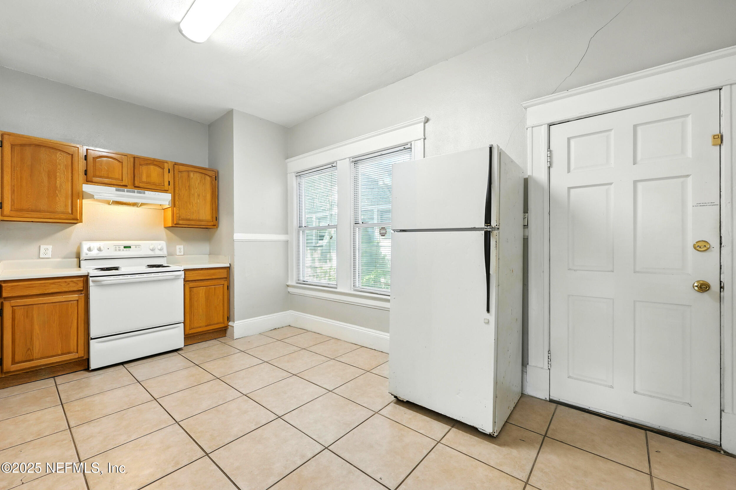 2805 Post Street Jacksonville, FL 32205 - Photo 11 of 23 a kitchen with a refrigerator sink and cabinets
