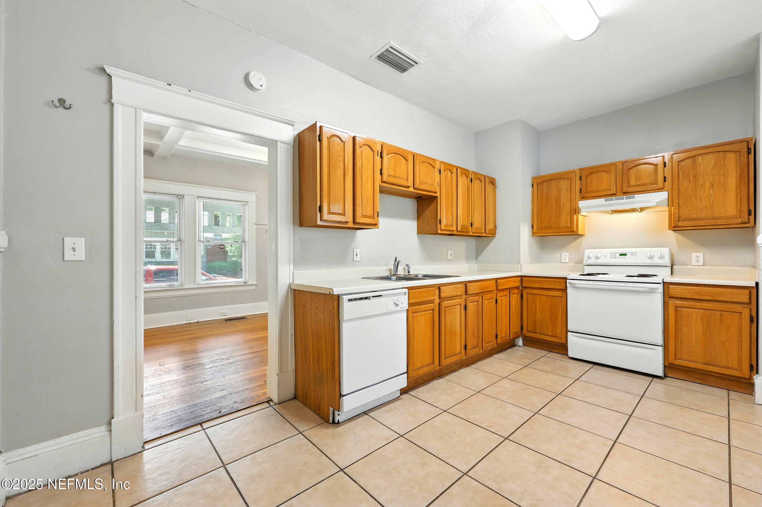 2805 Post Street Jacksonville, FL 32205 - Photo 9 of 23 a kitchen with a white cabinets appliances and a window
