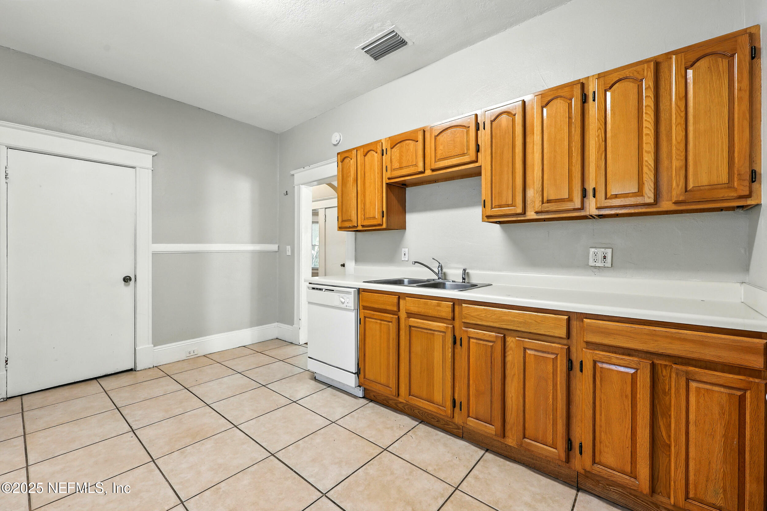 2805 Post Street Jacksonville, FL 32205 - Photo 10 of 23 a kitchen with stainless steel appliances a refrigerator sink and cabinets