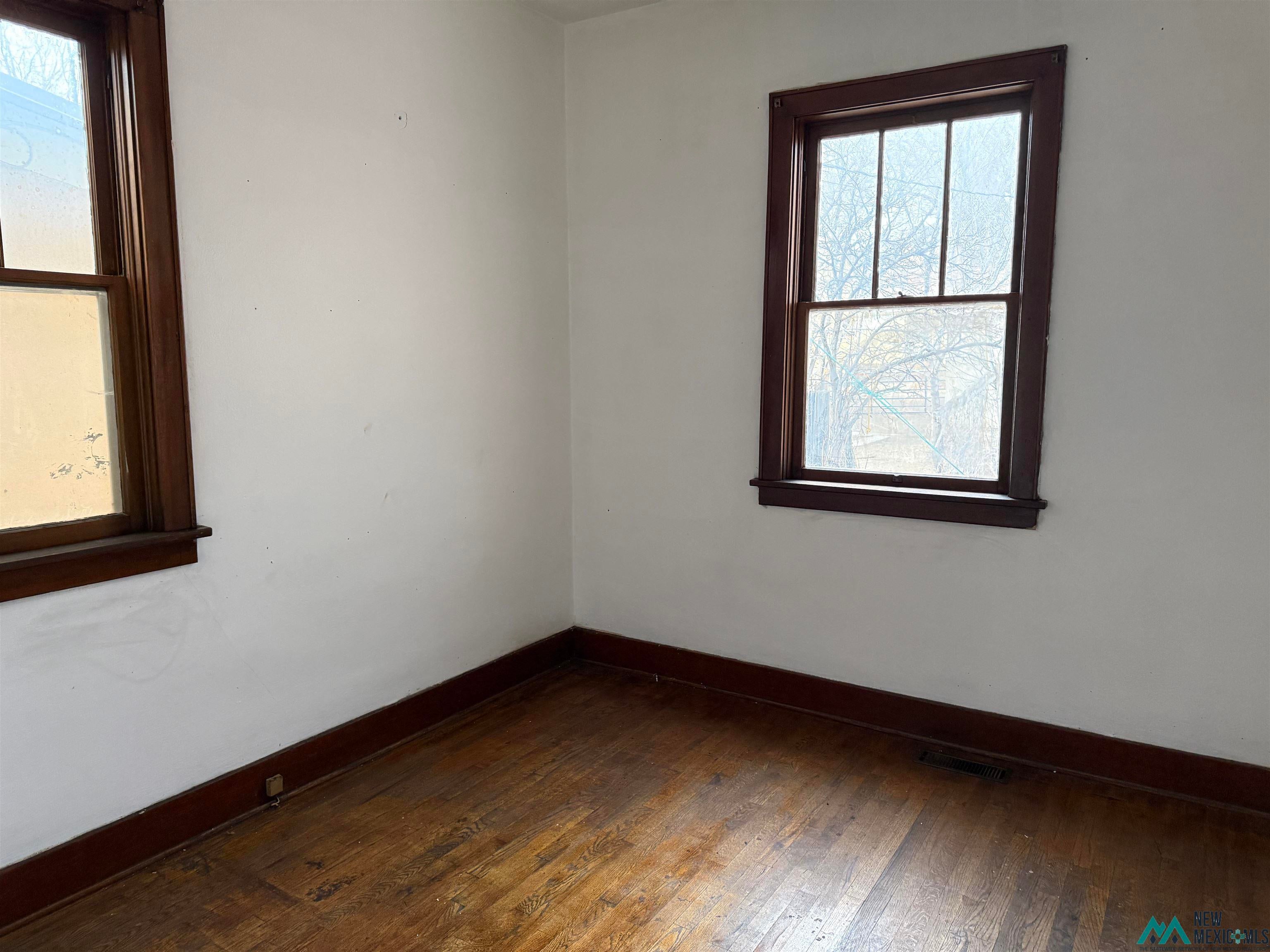 524 South 1st Street Raton, NM 87740 - Photo 14 of 21 Empty room featuring dark wood-style flooring and baseboards