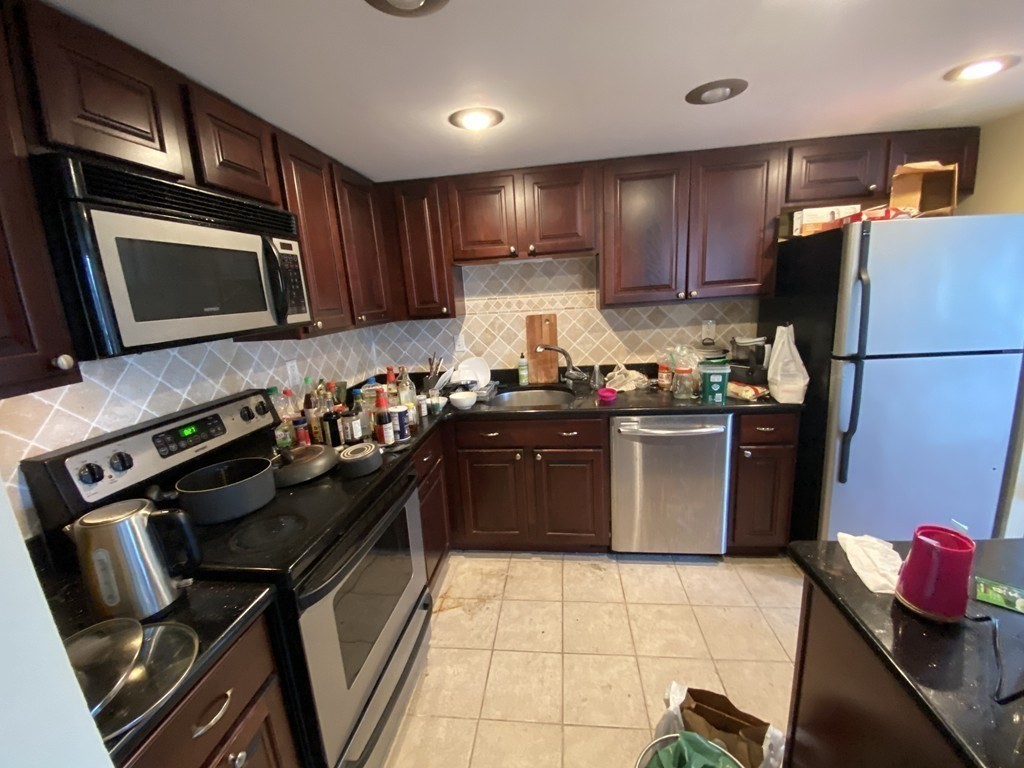 85 Brainerd Road, Unit 510 Boston, MA 02134 - Photo 4 of 25 a kitchen with a sink stainless steel appliances and cabinets