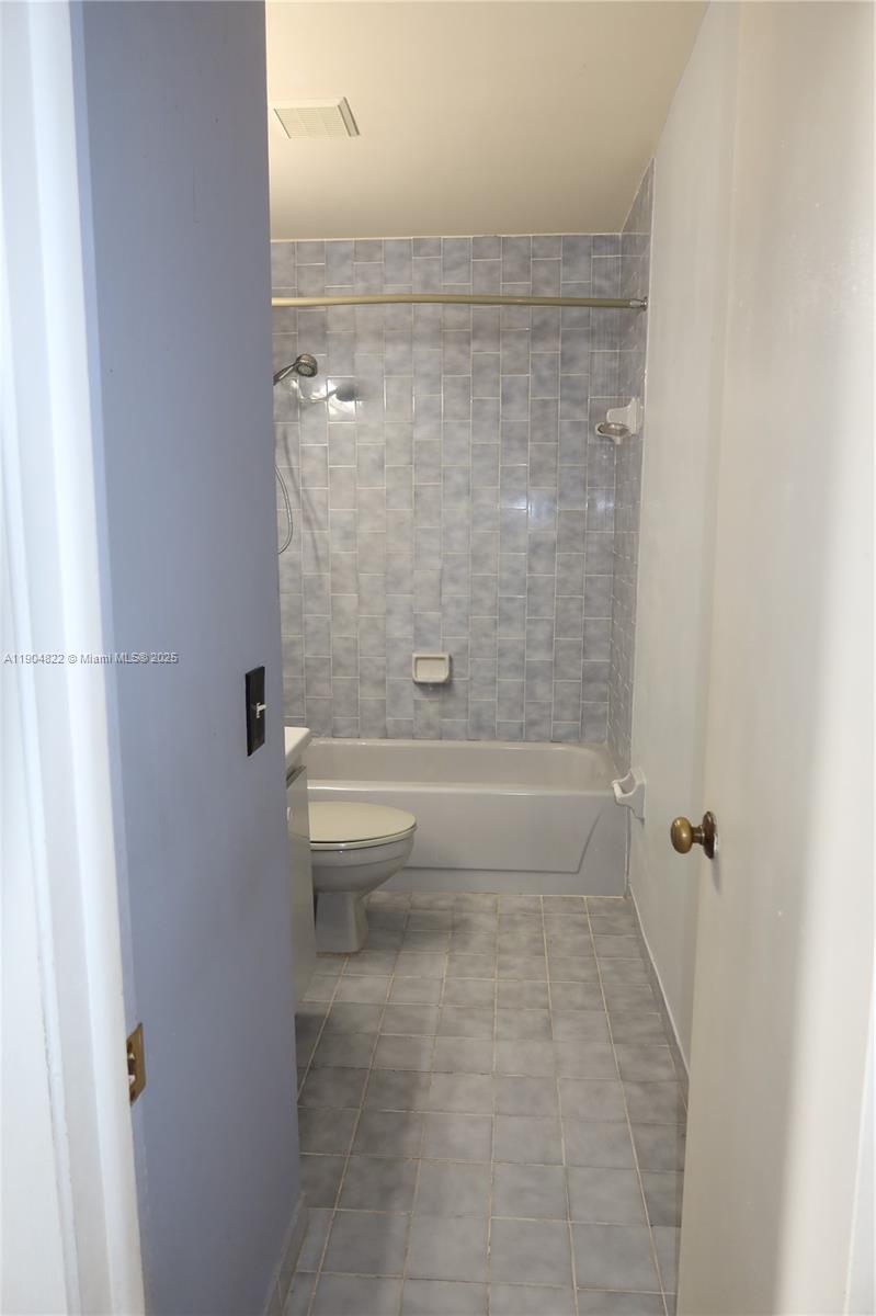 12059 Southwest 10th Street, Unit 201 Miami, FL 33184 - Photo 11 of 17 a bathroom with a shower and a toilet