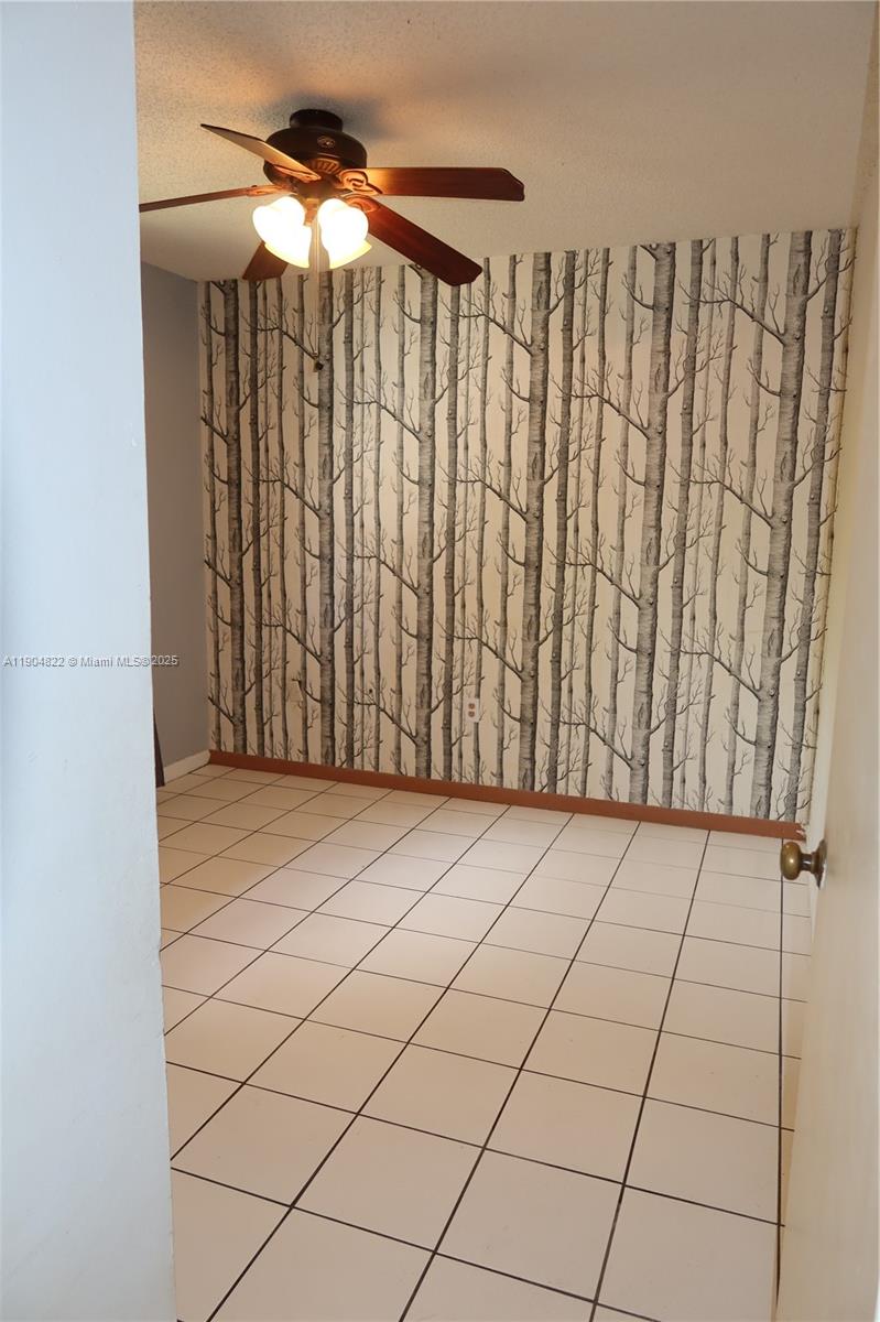 12059 Southwest 10th Street, Unit 201 Miami, FL 33184 - Photo 13 of 17 a view of a room with wooden walls