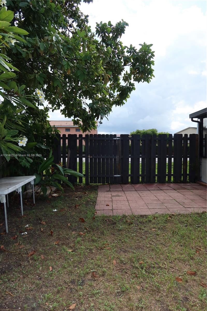 12059 Southwest 10th Street, Unit 201 Miami, FL 33184 - Photo 15 of 17 a patio with table and chairs