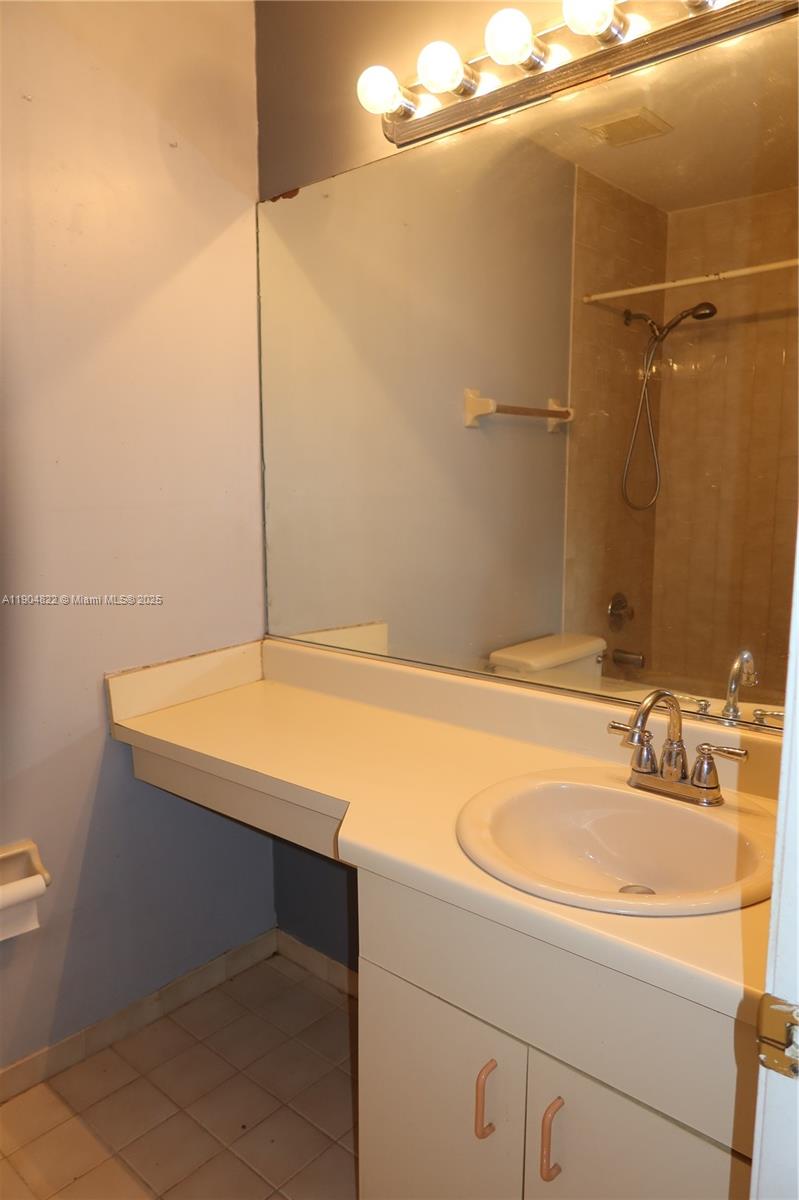 12059 Southwest 10th Street, Unit 201 Miami, FL 33184 - Photo 8 of 17 a bathroom with a sink and a mirror