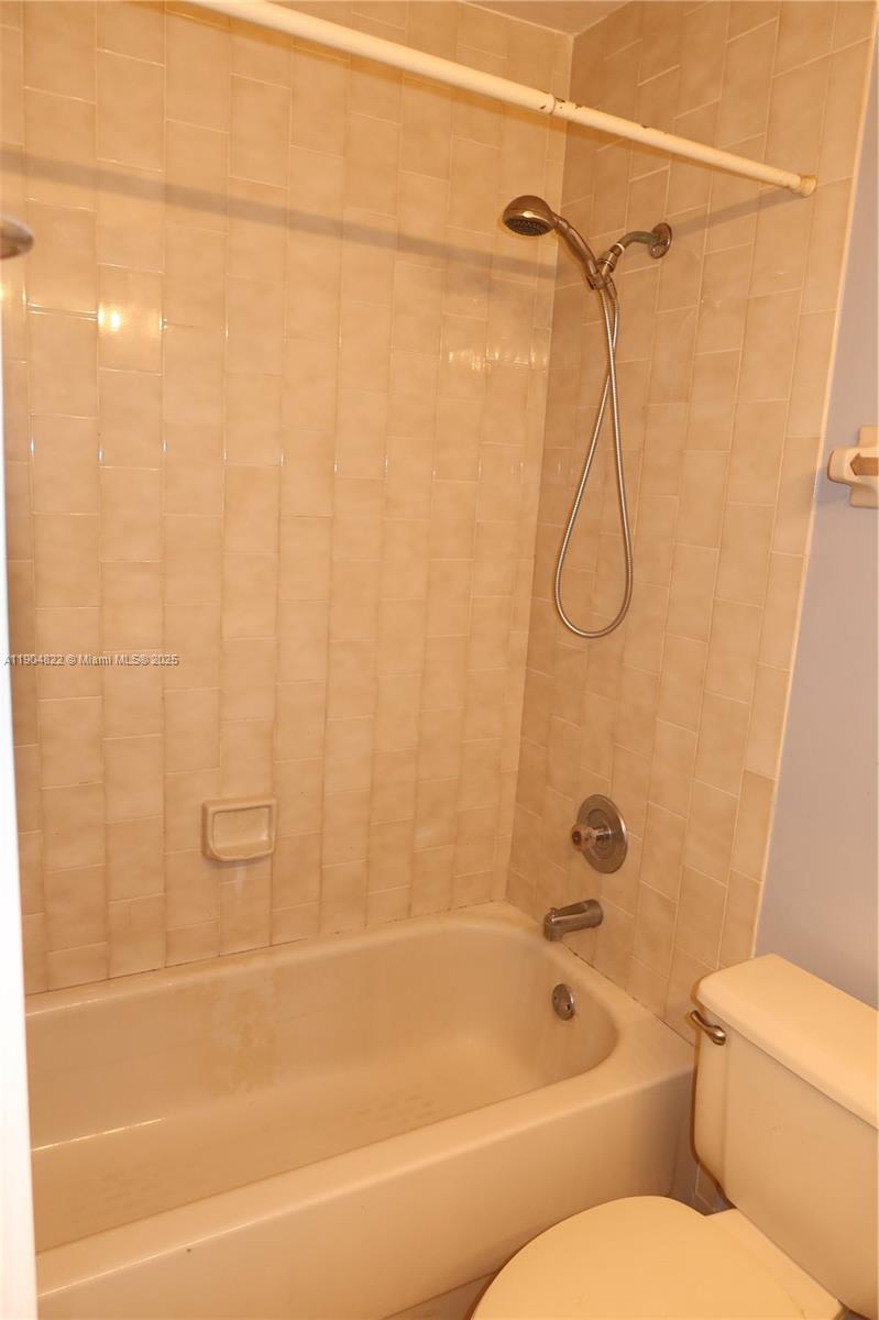 12059 Southwest 10th Street, Unit 201 Miami, FL 33184 - Photo 10 of 17 a bathroom with a shower and a toilet