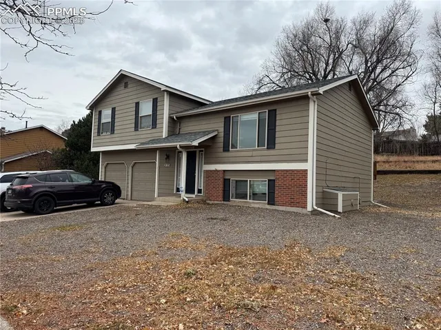 a view of a house with a yard and garage